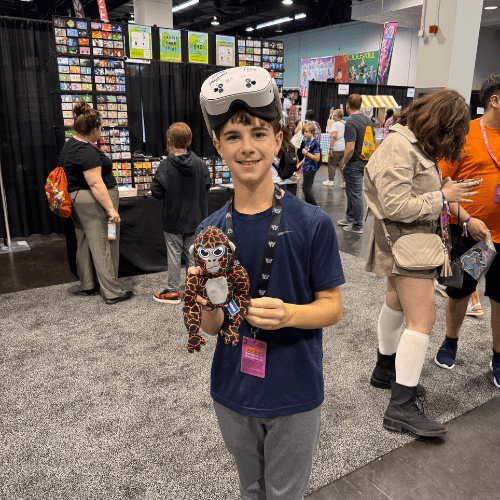 Smiling fan at Vidcon holding Tagged Monke Plush
